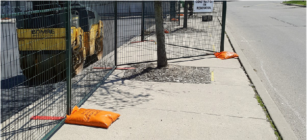 Sandbags help weigh down temporary fence bases