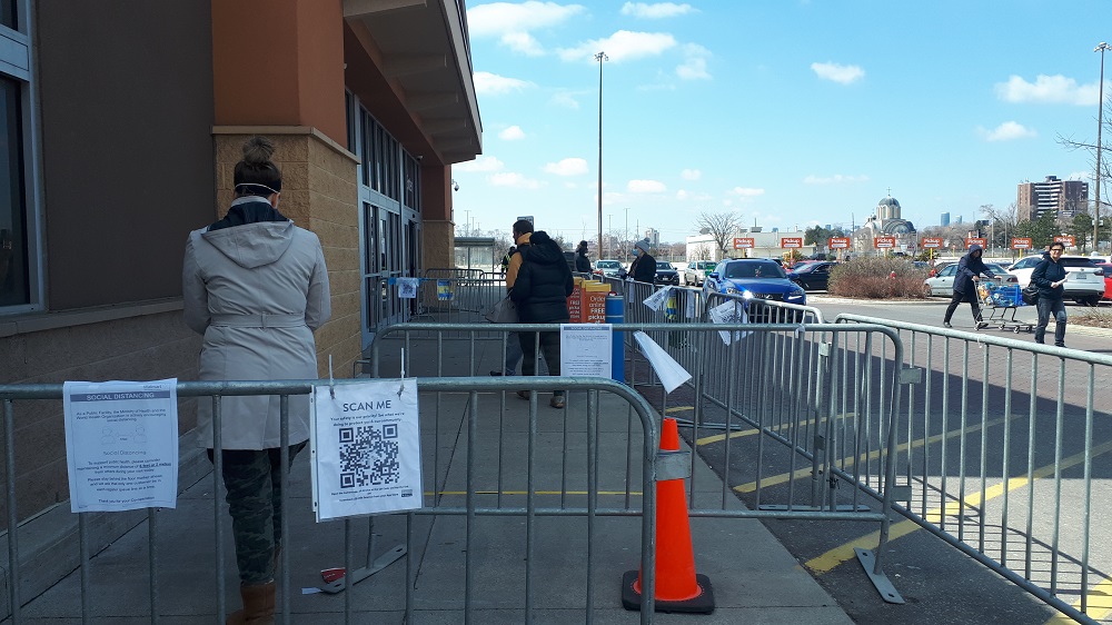 Temporary fence being used to create a snake queue outside a retail store