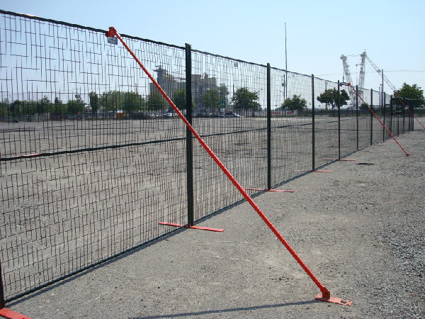 Wind braces secure temporary fence panels to the ground